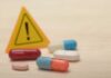 Blood Pressure Pills Fail – Nationwide Recall Pills with warning sign in background