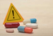 Blood Pressure Pills Fail – Nationwide Recall Pills with warning sign in background