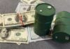 Oil Price Skyrockets: Saudi Pipeline Hit By Drone Green oil barrels on US dollar bills