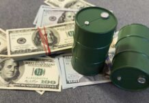 Green oil barrels on US dollar bills