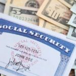 Social Security Shock Looms – DETAILS! A social security card placed on top of various denominations of U.S. currency