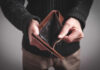 Person holding an open empty wallet