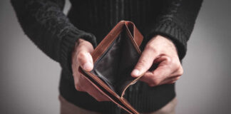 Person holding an open empty wallet
