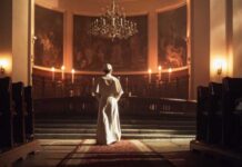 Unexpected Diagnosis Jolts The Papacy A religious figure standing in a church with candlelight illuminating the space