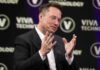 Musk’s Billion-Dollar Promise Elon Musk speaking on stage with hands raised during a talk