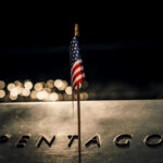 HUGE: Pentagon Doubles Down American flag above engraved Pentagon sign at night