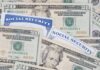 Surprise Tease in SSA Envelope A collection of twenty-dollar bills and social security cards