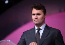 man in a suit speaking at a podium