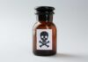 Brown glass bottle with skull and crossbones label