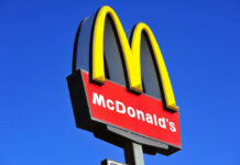 Riots Turn McDonald’s Into Chaos McDonalds logo on a pole clear sky