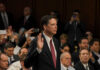Comey Faces TROUBLE James Comey raises his right hand during a formal hearing; Jared Coreau not visible